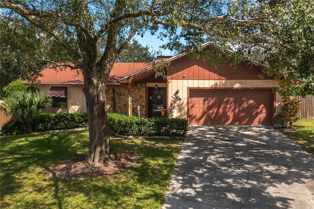 ranch-style home with a front lawn and a garage