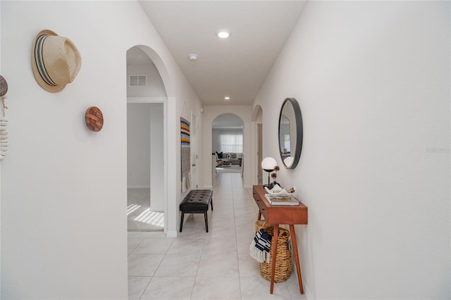 hall featuring light tile patterned floors