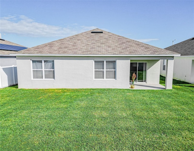 back of property with a patio and a lawn