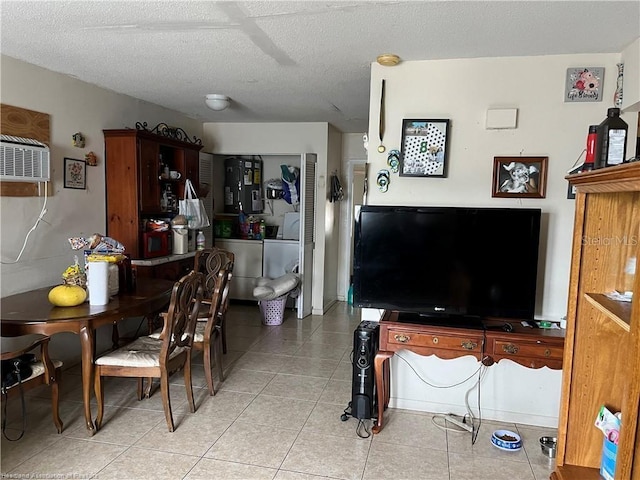 dining space with washing machine and dryer, a textured ceiling, and light tile patterned flooring