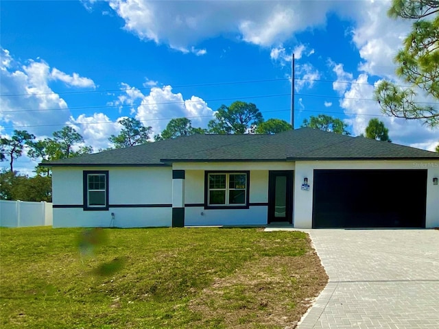 ranch-style house featuring a garage, stucco siding, fence, decorative driveway, and a front yard