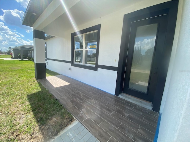 view of side of property with a yard and stucco siding