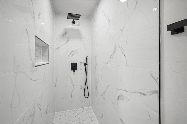 bathroom with tiled shower