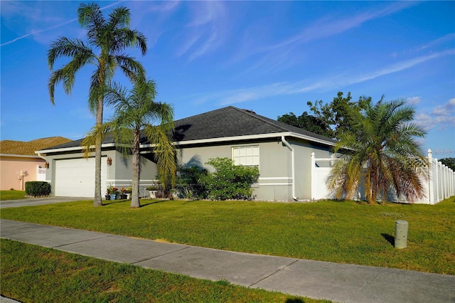 ranch-style home featuring a front yard and a garage