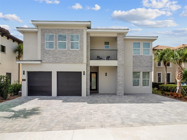 view of front facade with a balcony and a garage