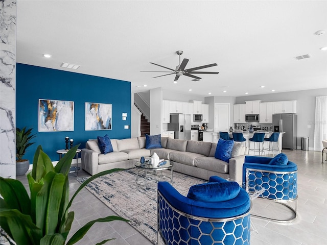 tiled living room featuring ceiling fan