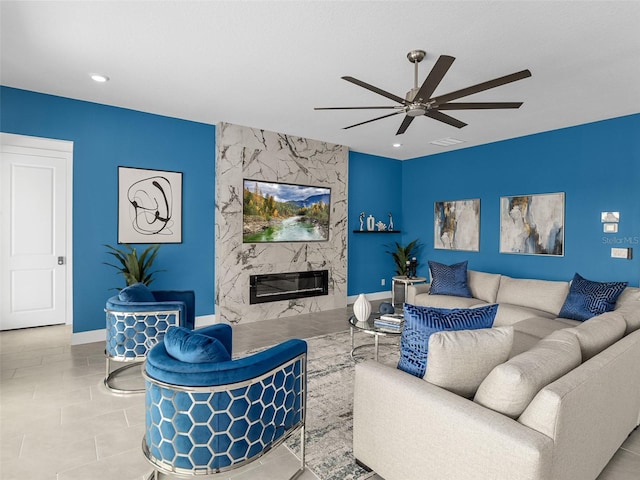 living room with ceiling fan, light tile patterned floors, and a fireplace