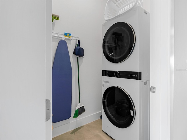 clothes washing area featuring stacked washer / drying machine