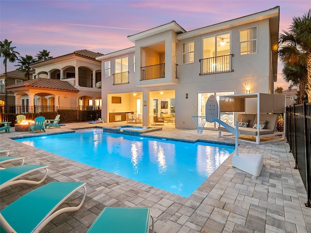 exterior space with an in ground hot tub and a patio area