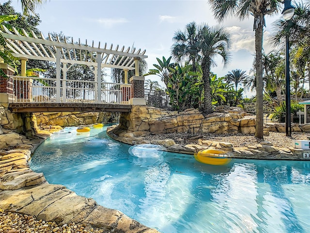 view of swimming pool with a pergola