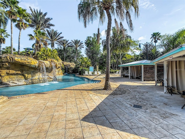 view of swimming pool with a patio and pool water feature