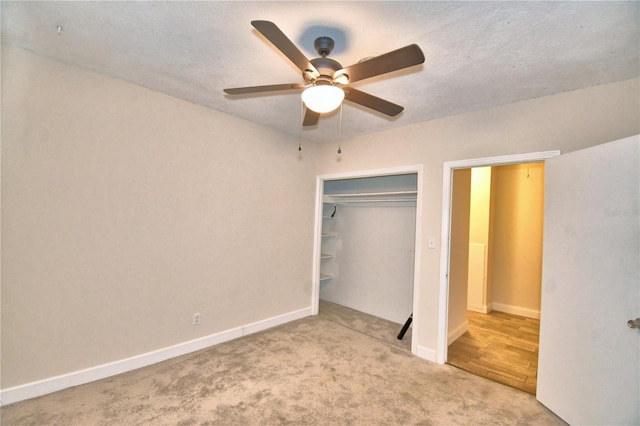 unfurnished bedroom with ceiling fan, carpet, and a closet