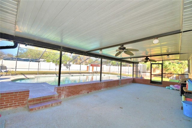 unfurnished sunroom featuring ceiling fan