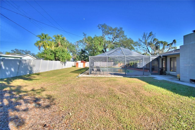 view of yard featuring a storage shed, a lanai, and a patio area