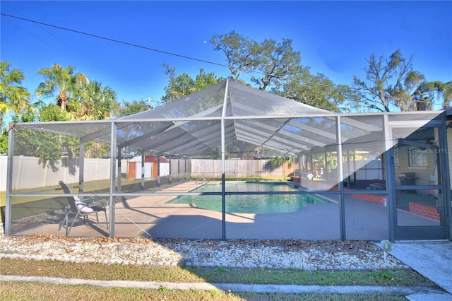 view of pool with a patio and glass enclosure