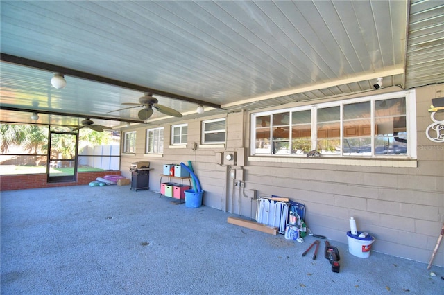 unfurnished sunroom featuring a healthy amount of sunlight and ceiling fan