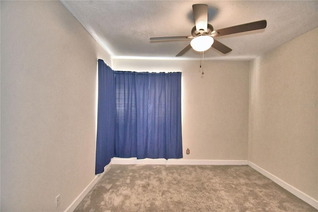 spare room with carpet floors and ceiling fan