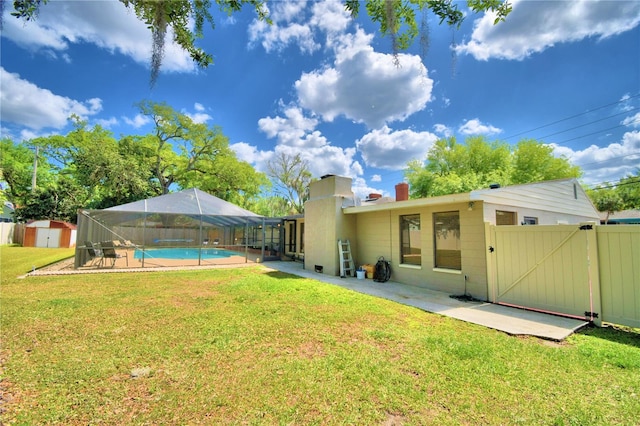 view of yard with a fenced in pool, a patio area, and glass enclosure