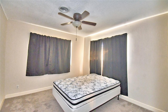 bedroom featuring ceiling fan and carpet