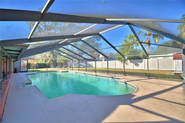 view of swimming pool featuring a lanai and a patio area