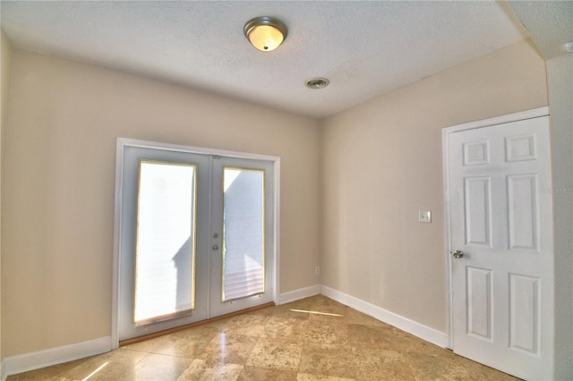 unfurnished room featuring french doors and a wealth of natural light