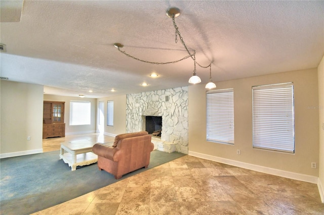 unfurnished living room featuring carpet flooring, a textured ceiling, and a fireplace