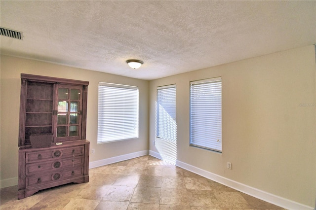 empty room featuring a textured ceiling