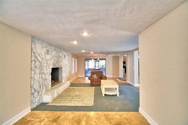 unfurnished living room featuring a stone fireplace and a textured ceiling