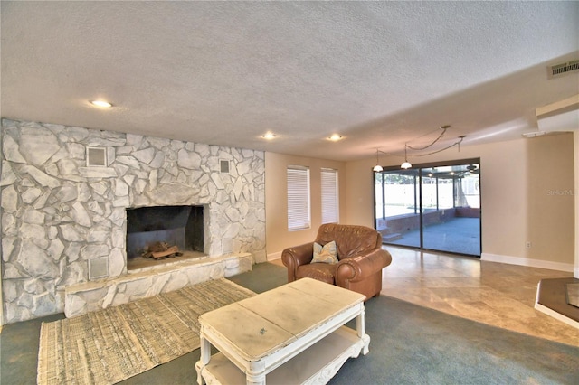 living room with a fireplace and a textured ceiling