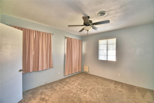 unfurnished room featuring ceiling fan and carpet