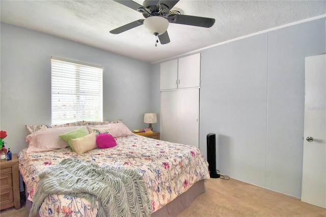 carpeted bedroom featuring a textured ceiling and ceiling fan