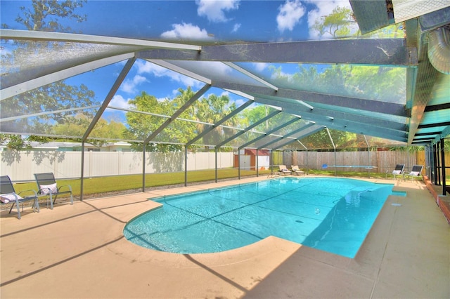 view of pool featuring a lanai, a shed, and a patio area