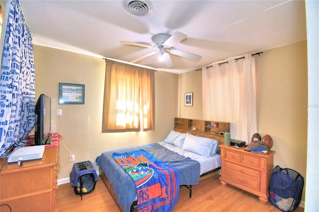 bedroom with light wood-type flooring and ceiling fan