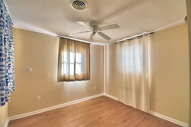 unfurnished room with hardwood / wood-style floors, a textured ceiling, and ceiling fan