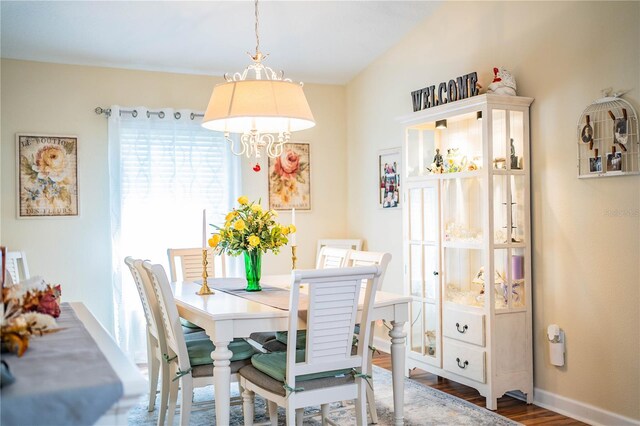 dining room with lofted ceiling and hardwood / wood-style flooring