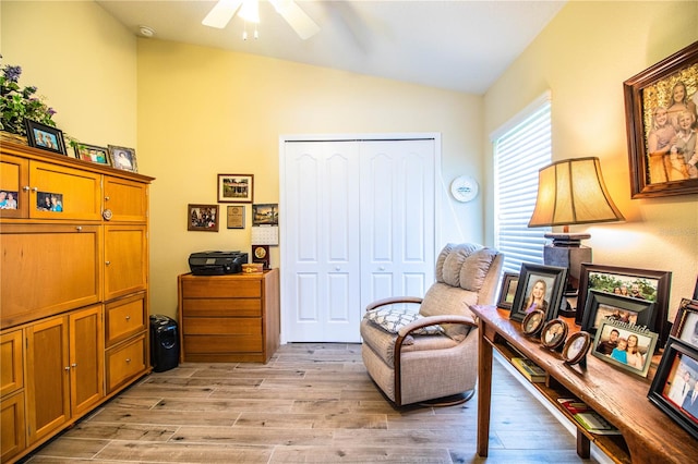 sitting room with light hardwood / wood-style flooring, vaulted ceiling, and ceiling fan