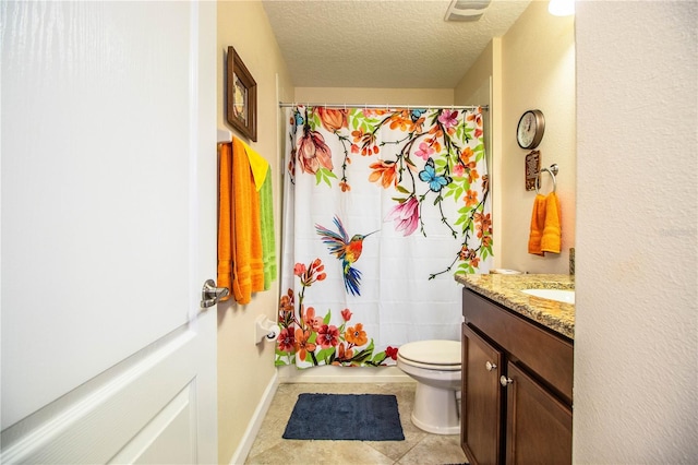 bathroom with toilet, tile patterned flooring, vanity, a textured ceiling, and walk in shower