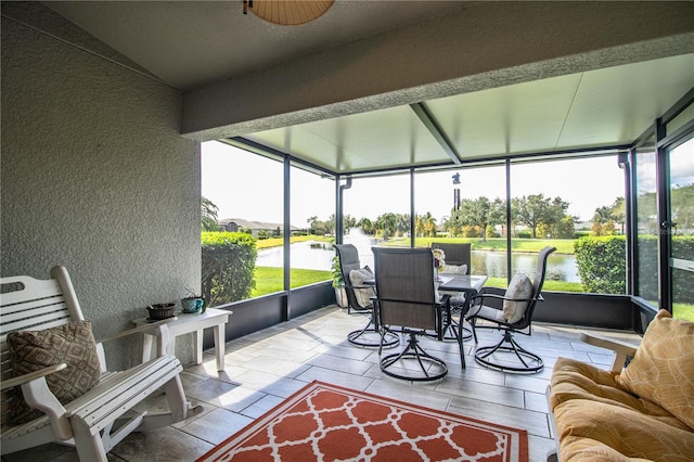 sunroom with a healthy amount of sunlight and a water view