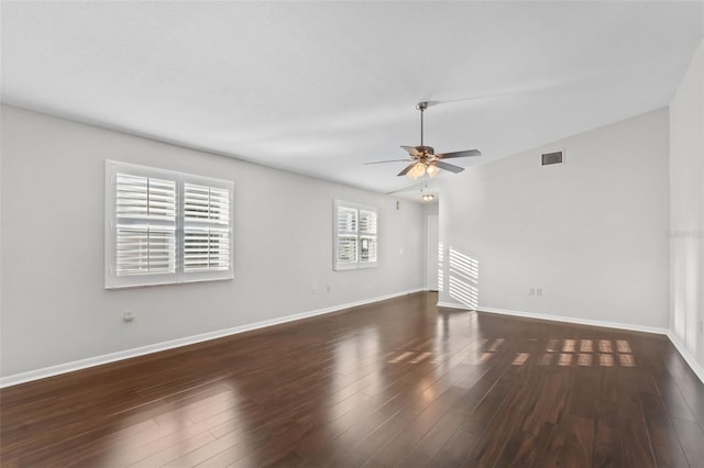 spare room with lofted ceiling, dark hardwood / wood-style floors, and ceiling fan