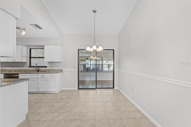 kitchen featuring white cabinetry, pendant lighting, vaulted ceiling, and a notable chandelier