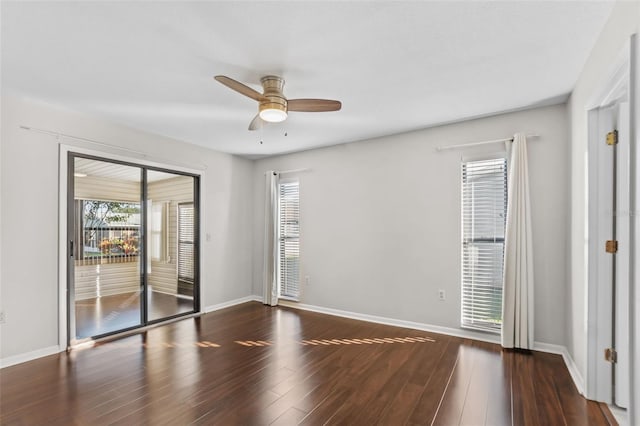 empty room with baseboards, wood finished floors, and ceiling fan