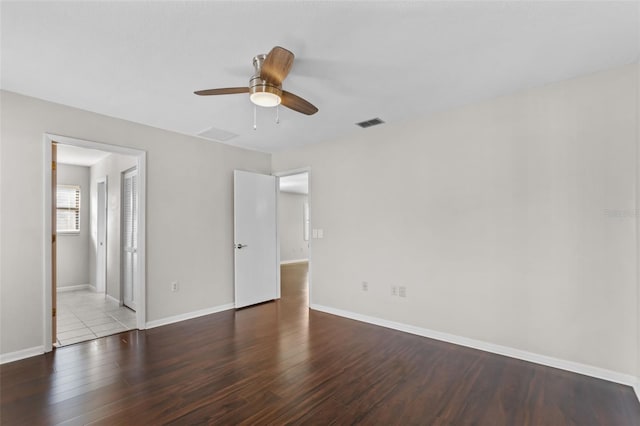 unfurnished bedroom with connected bathroom, wood-type flooring, and ceiling fan