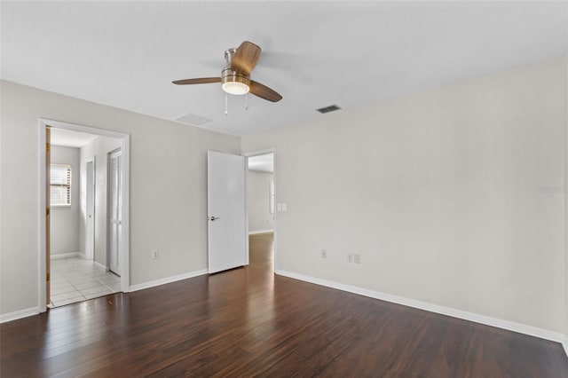 unfurnished bedroom with baseboards, visible vents, wood finished floors, and ceiling fan
