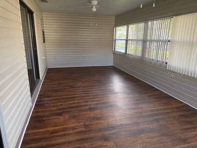 unfurnished sunroom featuring ceiling fan