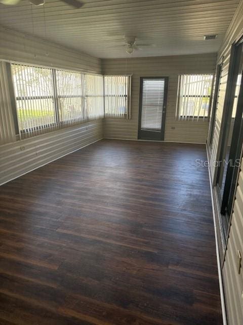 unfurnished sunroom featuring ceiling fan