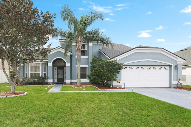 view of front of property featuring a front yard and a garage