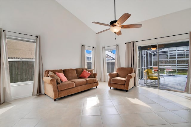 living room featuring high vaulted ceiling, light tile patterned floors, and ceiling fan