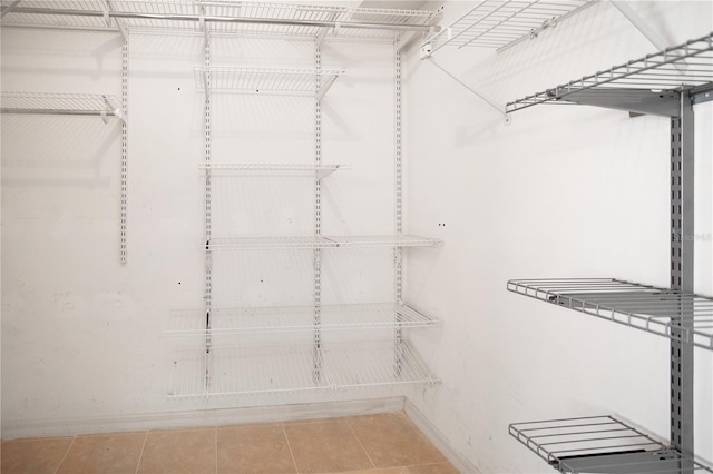 walk in closet featuring light tile patterned flooring