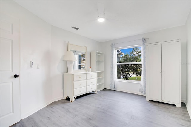 unfurnished bedroom with light hardwood / wood-style floors and ceiling fan