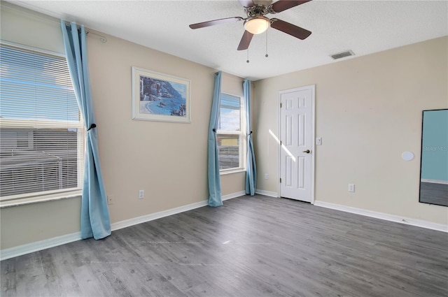 unfurnished room with a textured ceiling, hardwood / wood-style flooring, and ceiling fan